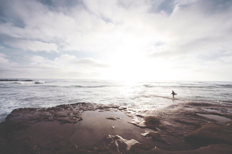 Free Image of Person Standing on Beach With Surfboard 