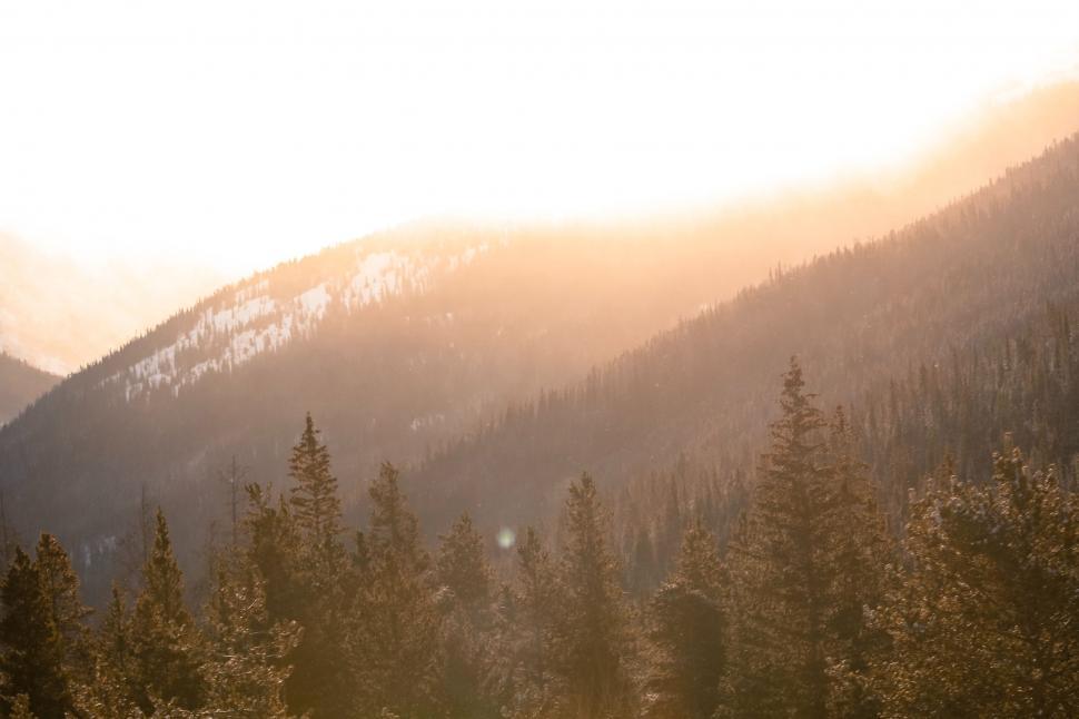 Free Image of The Sun Shines on the Mountains in the Distance 