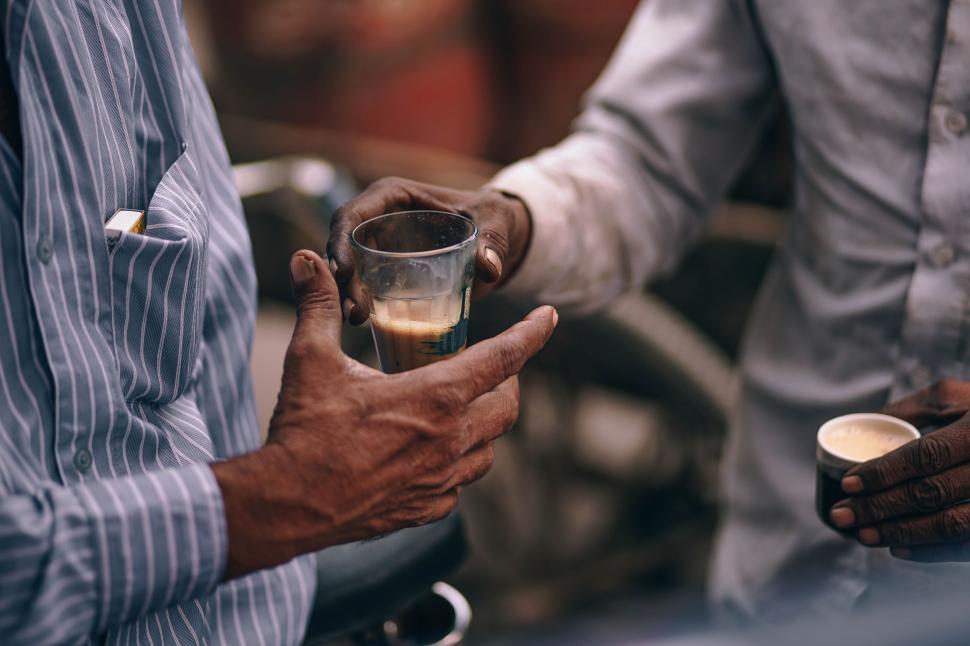 Free Image of Two Men Holding Glasses of Liquid 