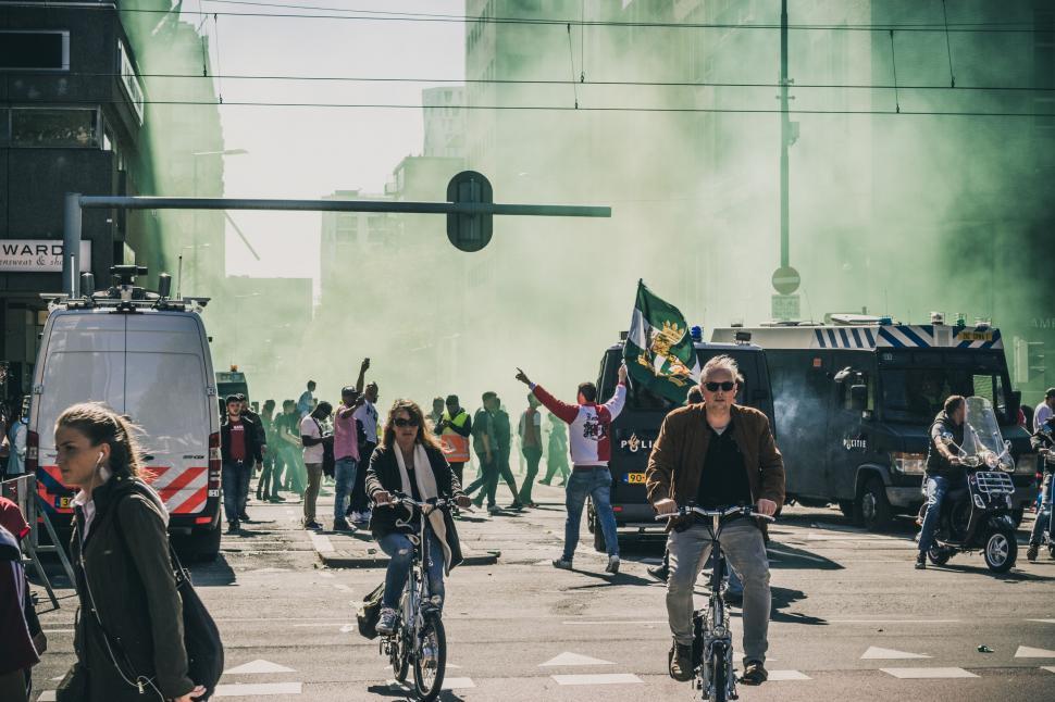 Free Image of A Group of People Riding Bikes Down a Street 