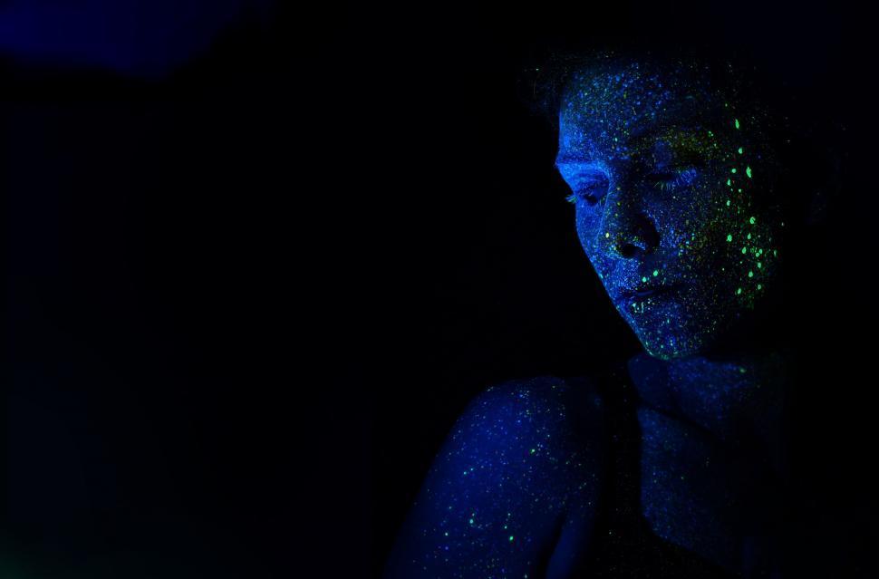 Free Image of Woman With Blue Body Paint in the Dark 