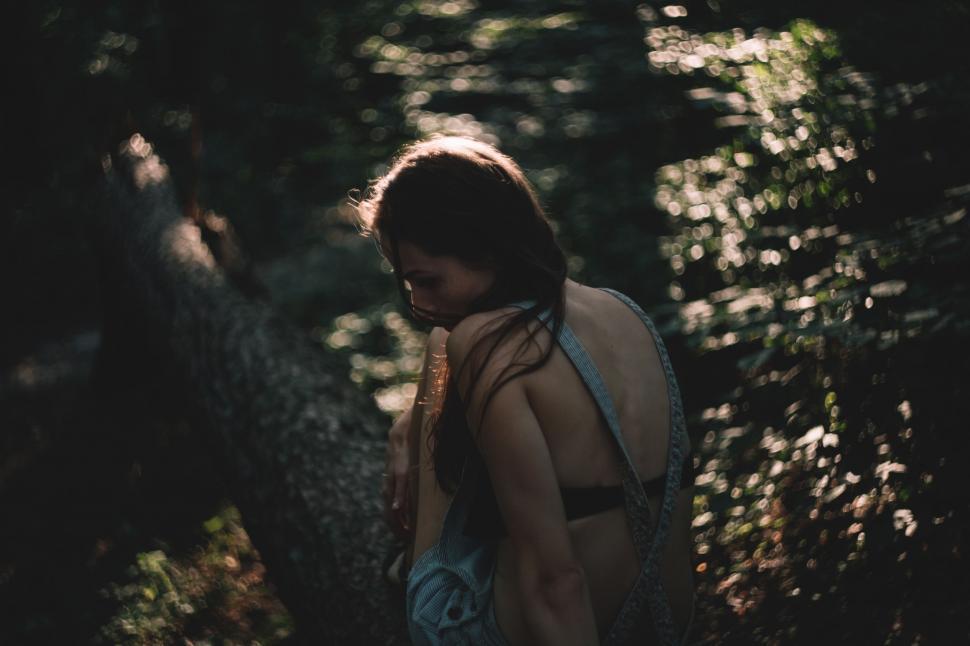 Free Image of Woman Walking Through Forest at Night 