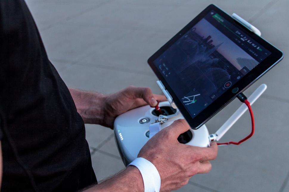 Free Image of Man Holding Tablet and Camera 