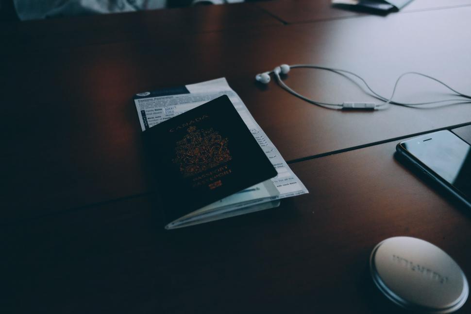 Free Image of Table With Cell Phone, Headphones, and Newspaper 