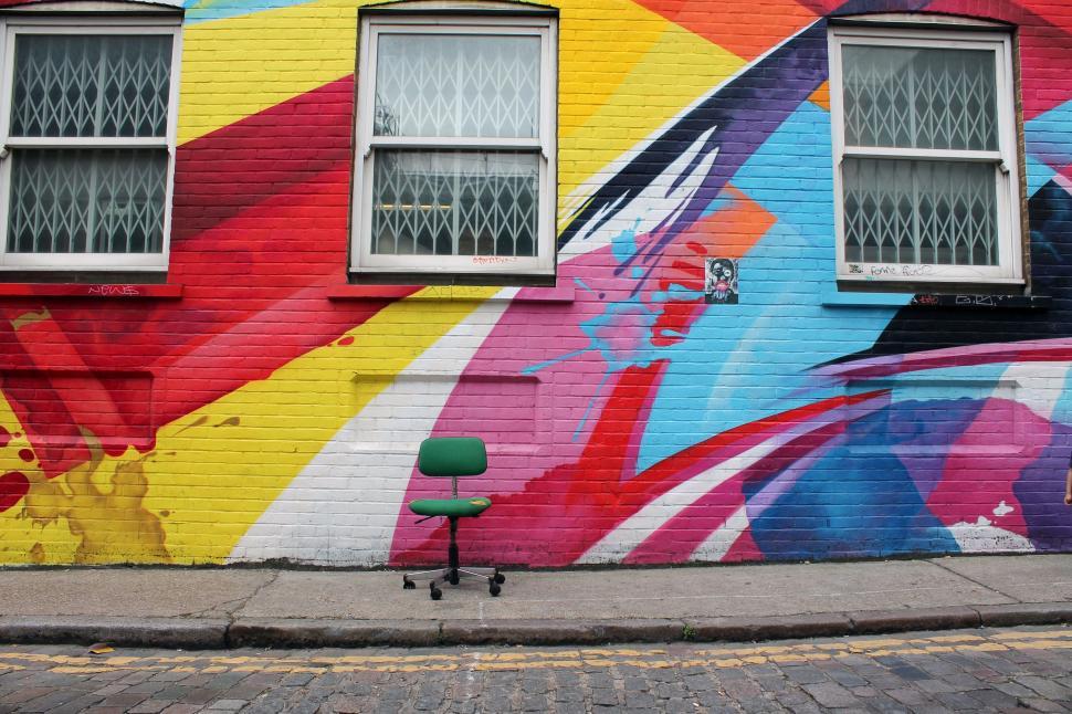 Free Image of Colorful Building With Green Chair 