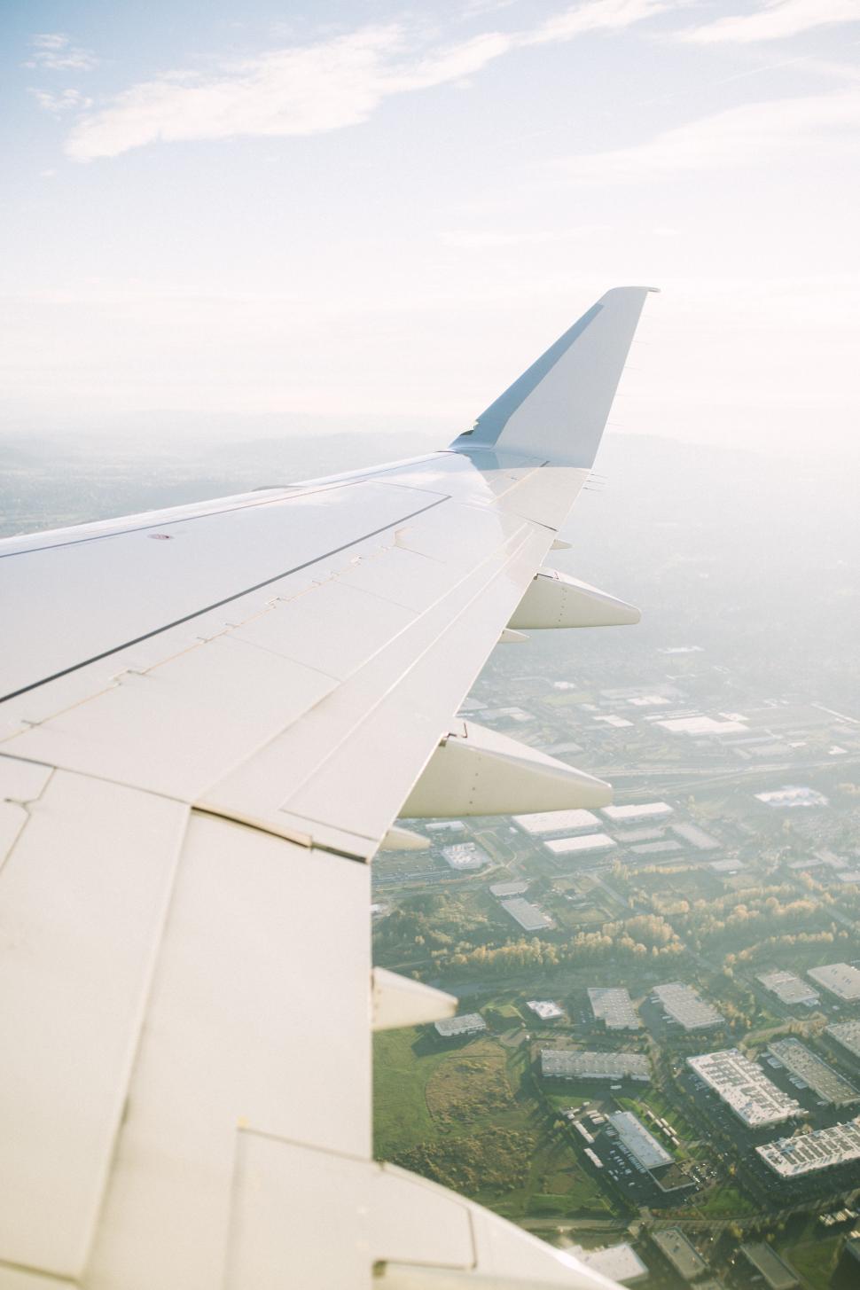Free Image of Airplane Wing Over City 