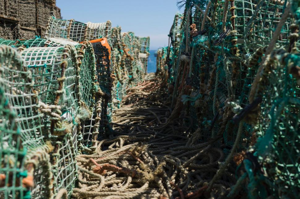 Free Stock Photo of Fishing Nets Arranged on Boat Side