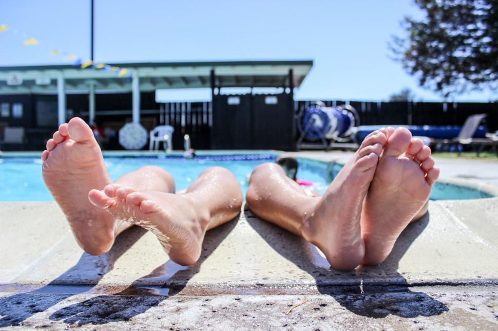 Free Image of Person Laying Beside Swimming Pool 