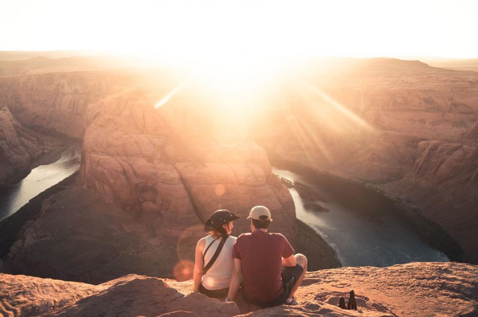 Free Image of Couple Sitting on Mountain Summit 