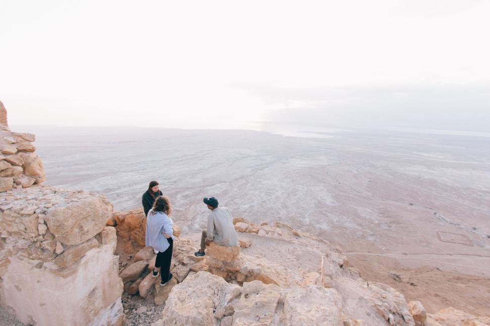 Free Image of Group of People Standing on Top of a Mountain 