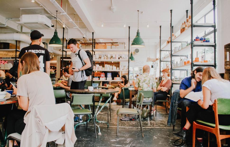 Free Image of Group of People Dining at Tables in a Restaurant 