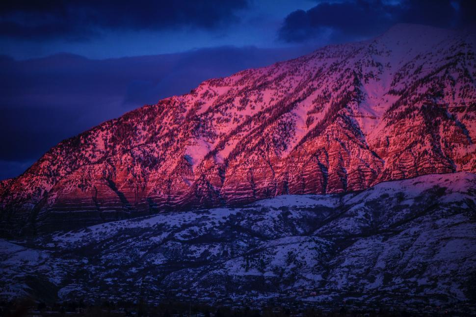 Free Image of Snow-Covered Mountain Under Cloudy Sky 