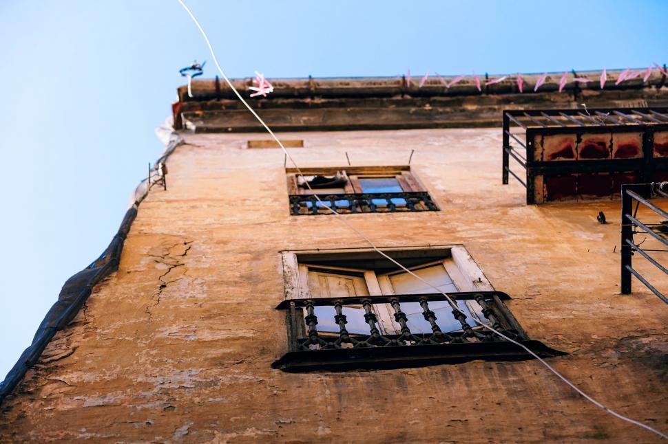 Free Image of Tall Building With Windows Against Sky Background 