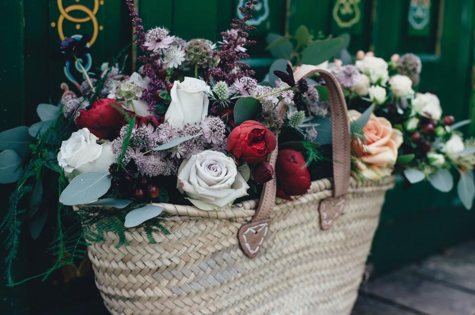 Free Image of Basket Filled With Flowers on Wooden Floor 