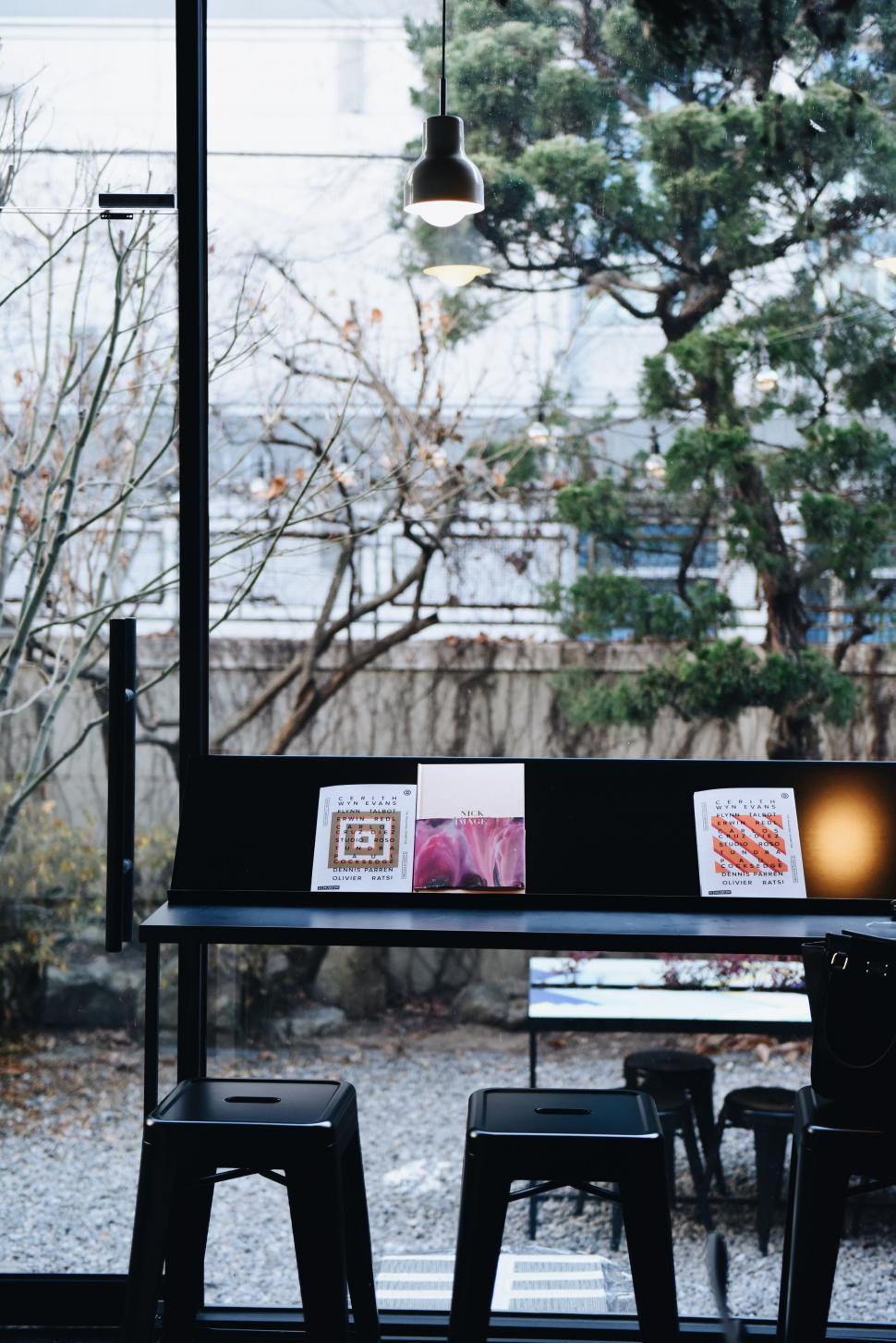 Free Image of Table and Two Stools by Window 