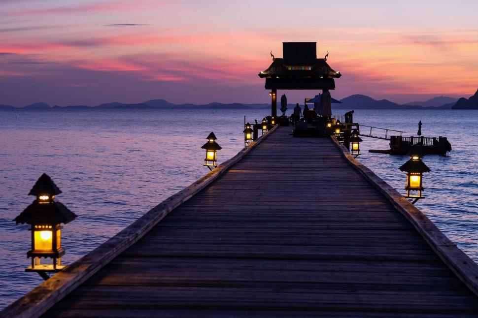 Free Image of Pier With Lit Lanterns at Night 