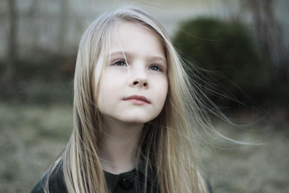 Free Image of Girl With Long Hair Standing in a Field 