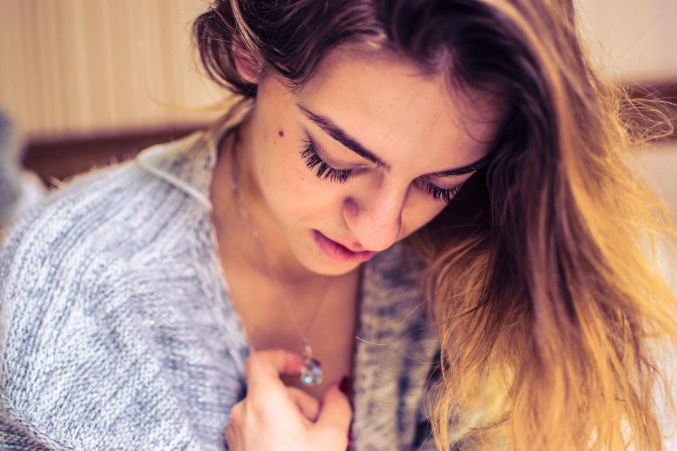Free Image of Woman Looking Down at Her Cell Phone 