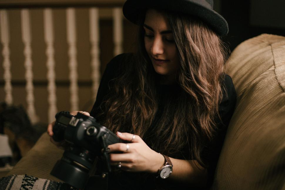 Free Image of Woman Sitting on Couch Holding Camera 