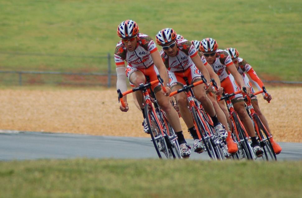 Free Image of Group of People Riding Bikes Down a Road 
