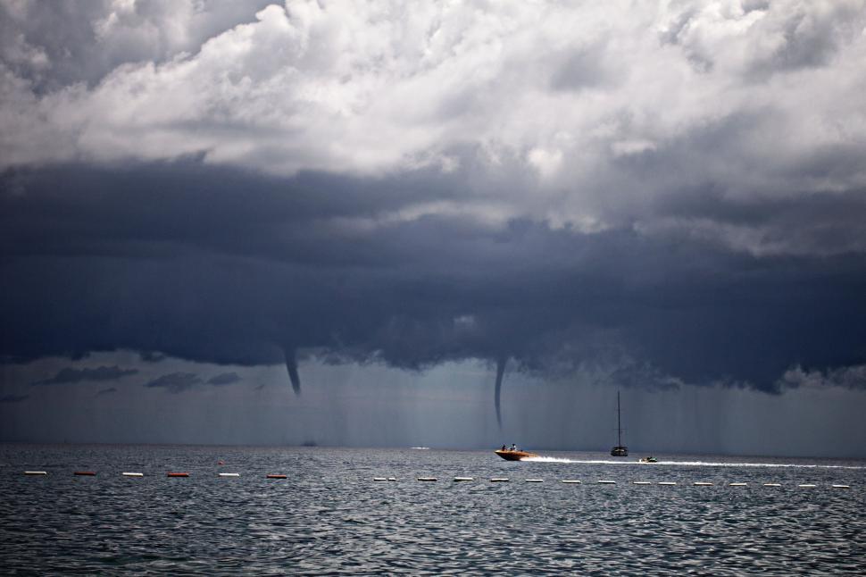 Free Image of Boat Sailing in Large Water Body Under Cloudy Sky 