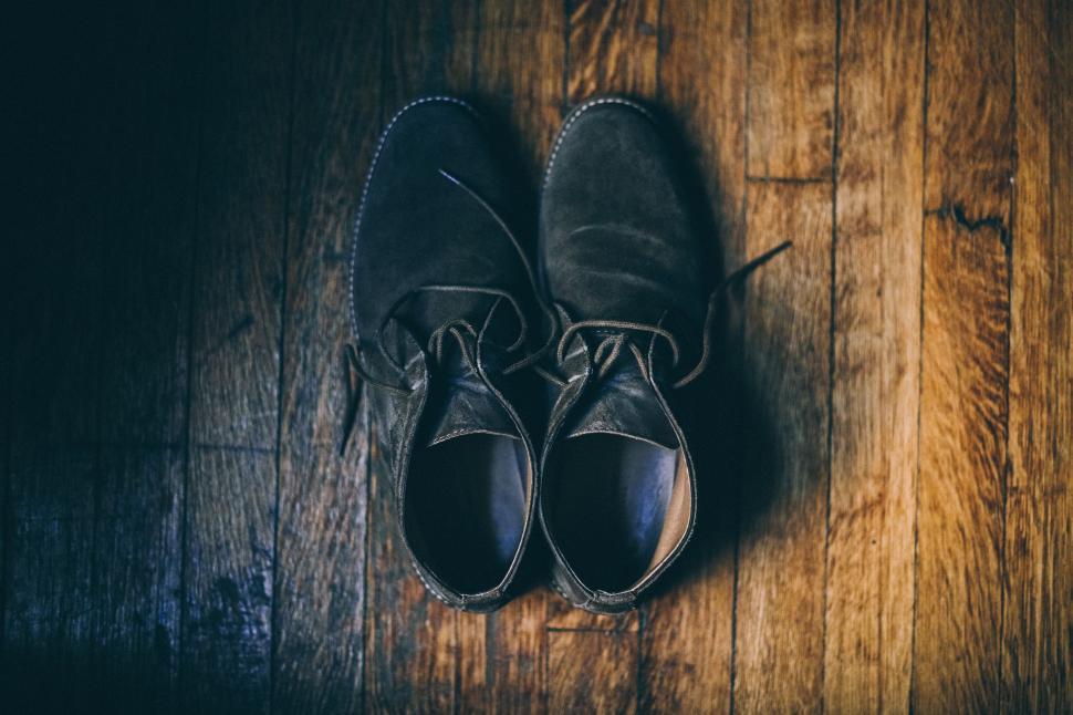 Free Image of A Pair of Shoes on Wooden Floor 