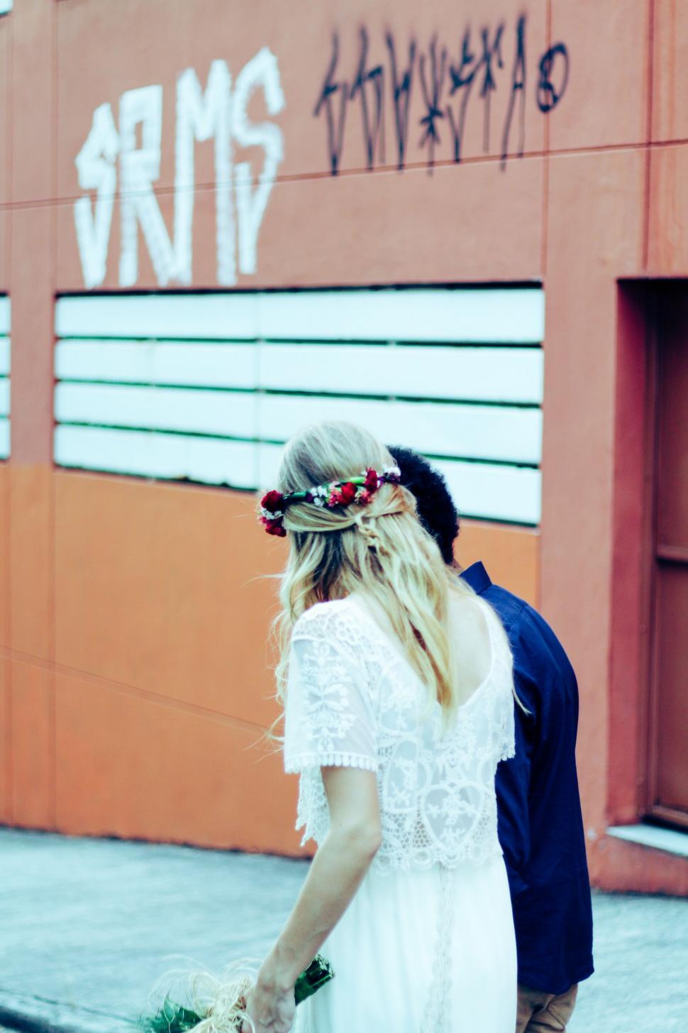 Free Image of Man and Woman Walking Down a Street 