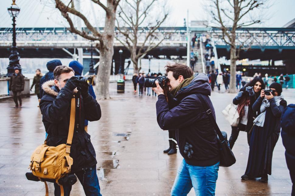 Free Image of Group of People Standing on Sidewalk in Rain 