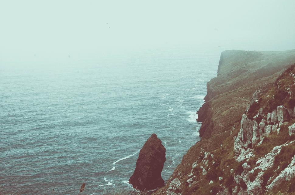 Free Image of Person Standing on Cliff Overlooking Ocean 