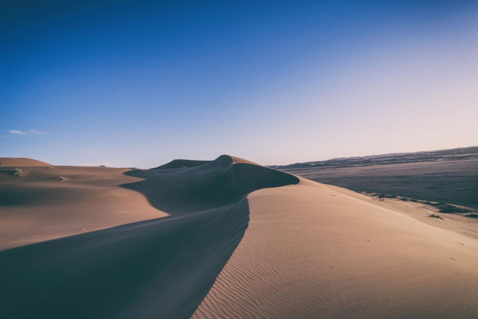Free Image of Massive Sand Dune Rising in Desert Landscape 