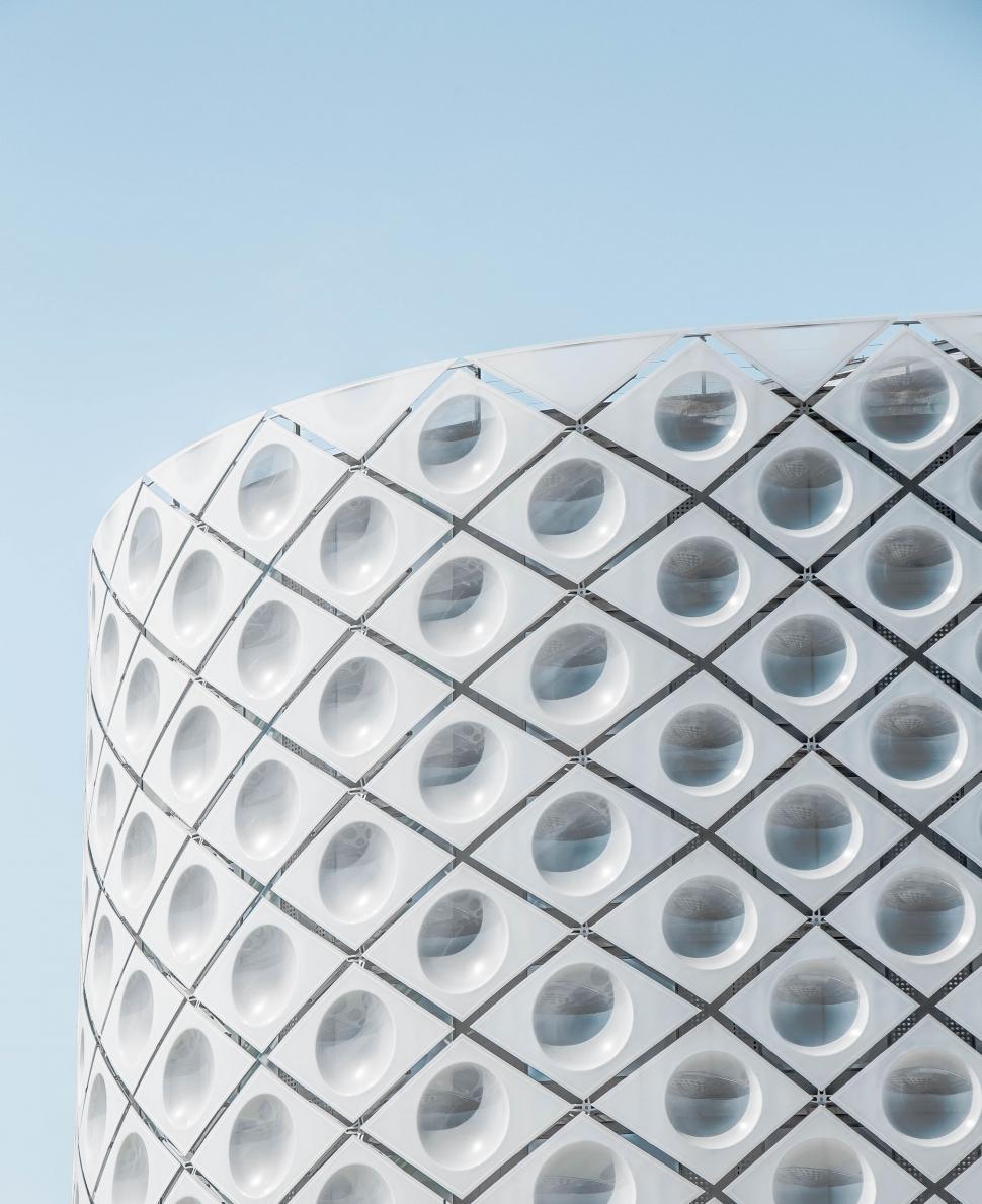 Free Image of Tall White Building With Holes 