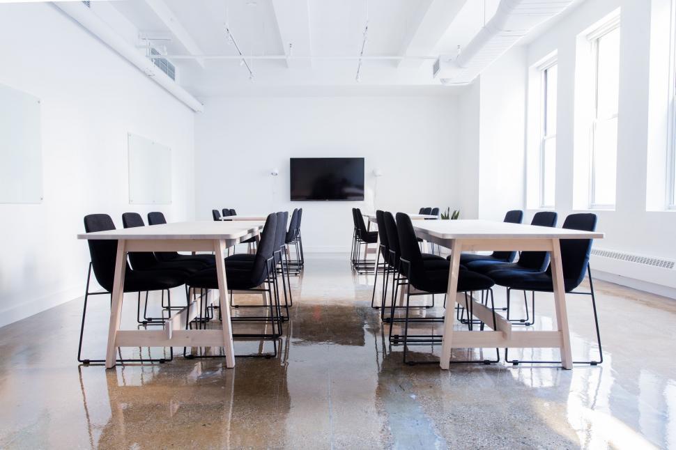 Free Image of A Room With Table, Chairs, and Projector Screen 