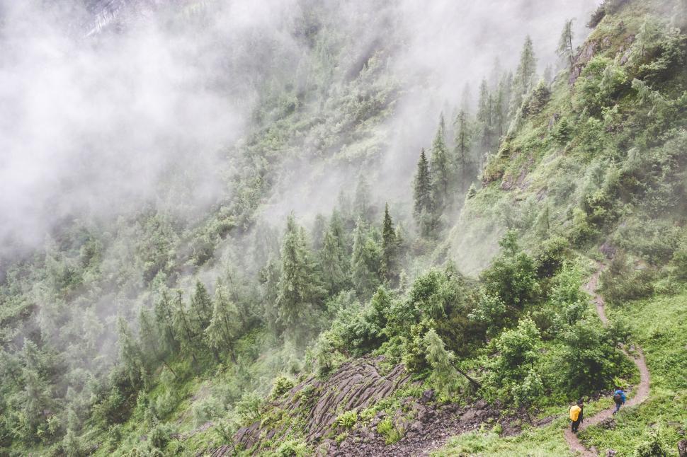 Free Image of Man Hiking Up Mountain With Backpack 
