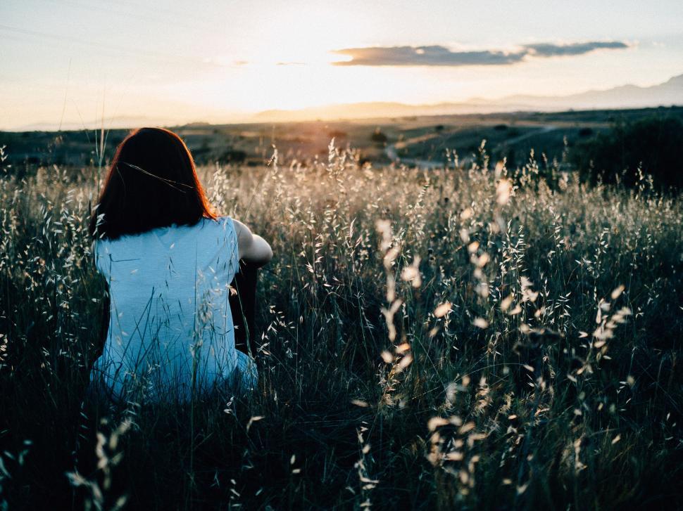 Free Image of Woman Sitting in Tall Grass Field 