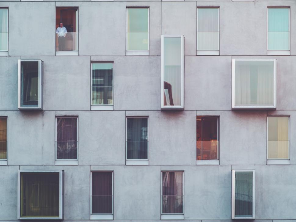 Free Image of Tall Building With Lots of Windows Next to a Parking Meter 