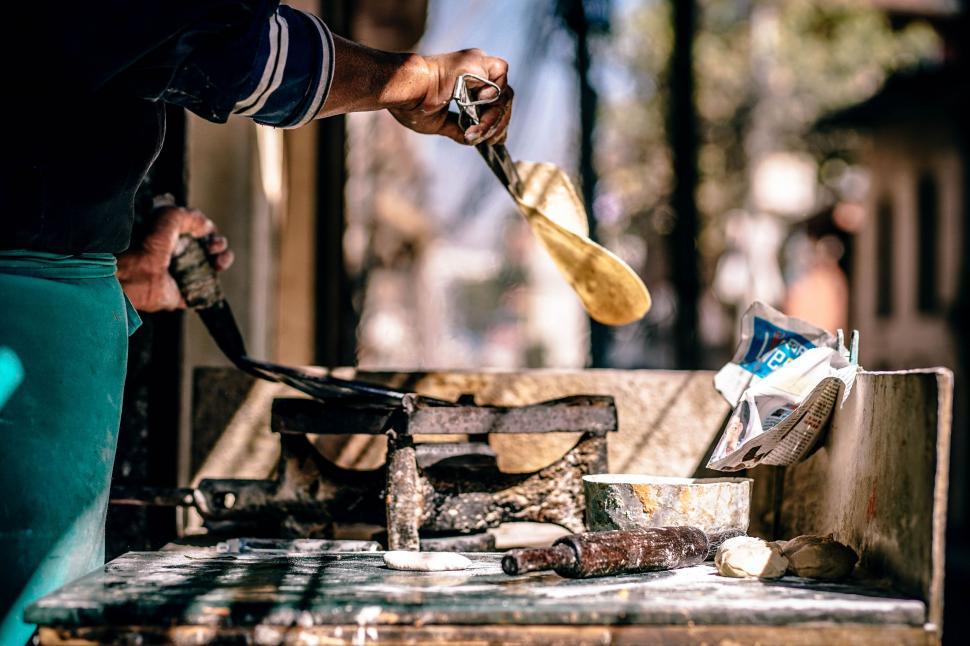 Free Image of Man Using Paddle to Cut Wood 