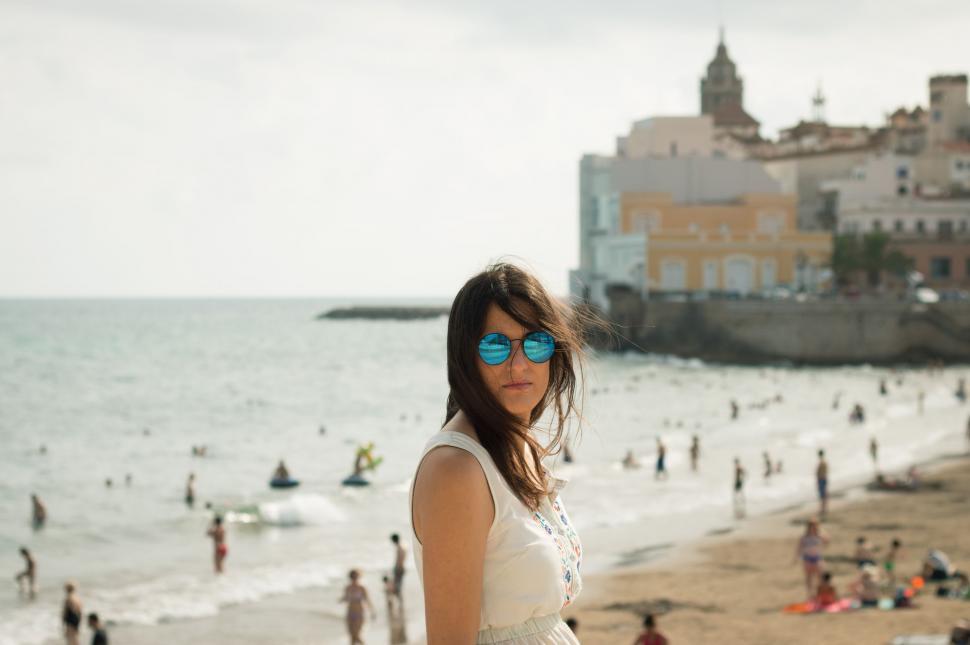 Free Image of Woman Standing on Top of Beach Next to Ocean 