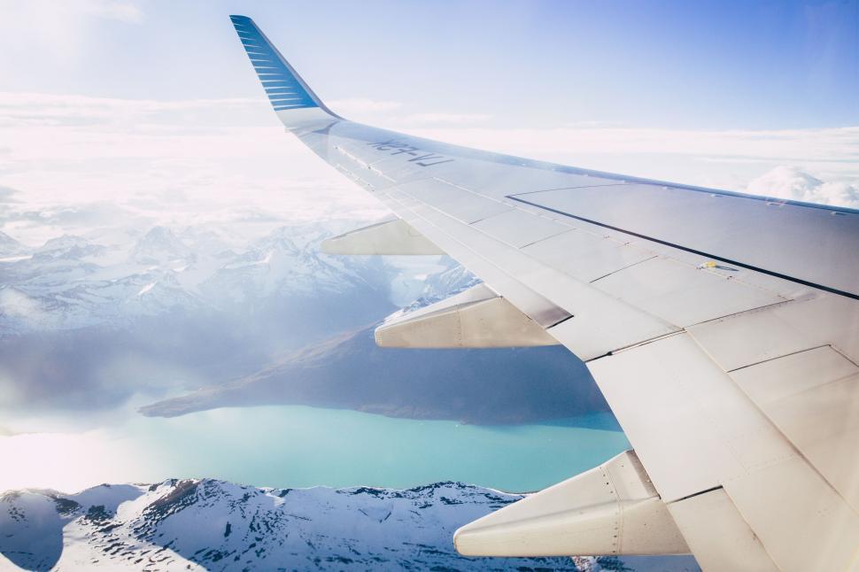 Free Image of Airplane Wing Soaring Over Mountain Range 