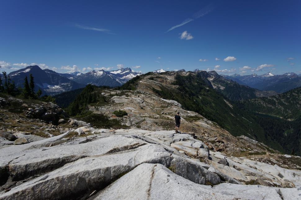 Free Image of Man Standing on Top of Rocky Mountain 