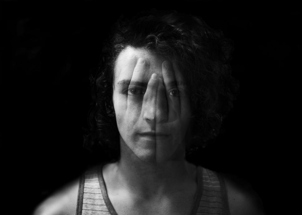 Free Image of Woman Covering Face With Hands 