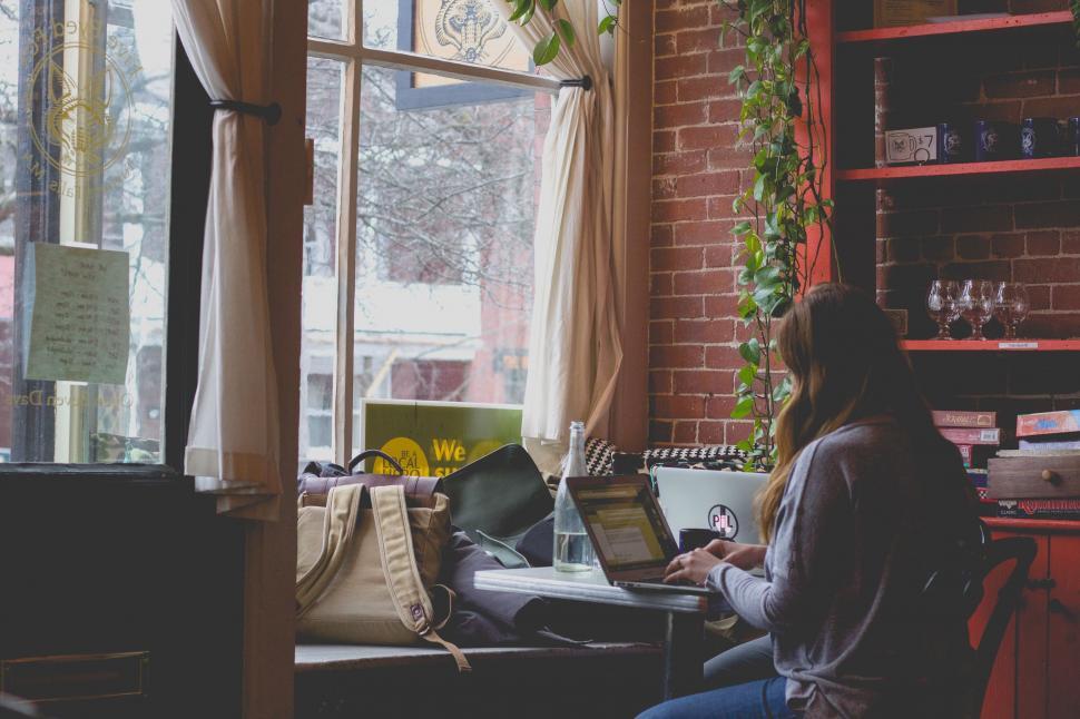Free Image of Woman Using Laptop Computer at Table 