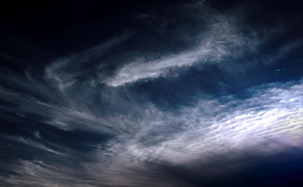 Free Image of Plane Flying Through Cloudy Blue Sky 