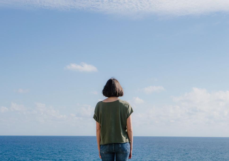 Free Image of Person Standing on Cliff Overlooking Ocean 