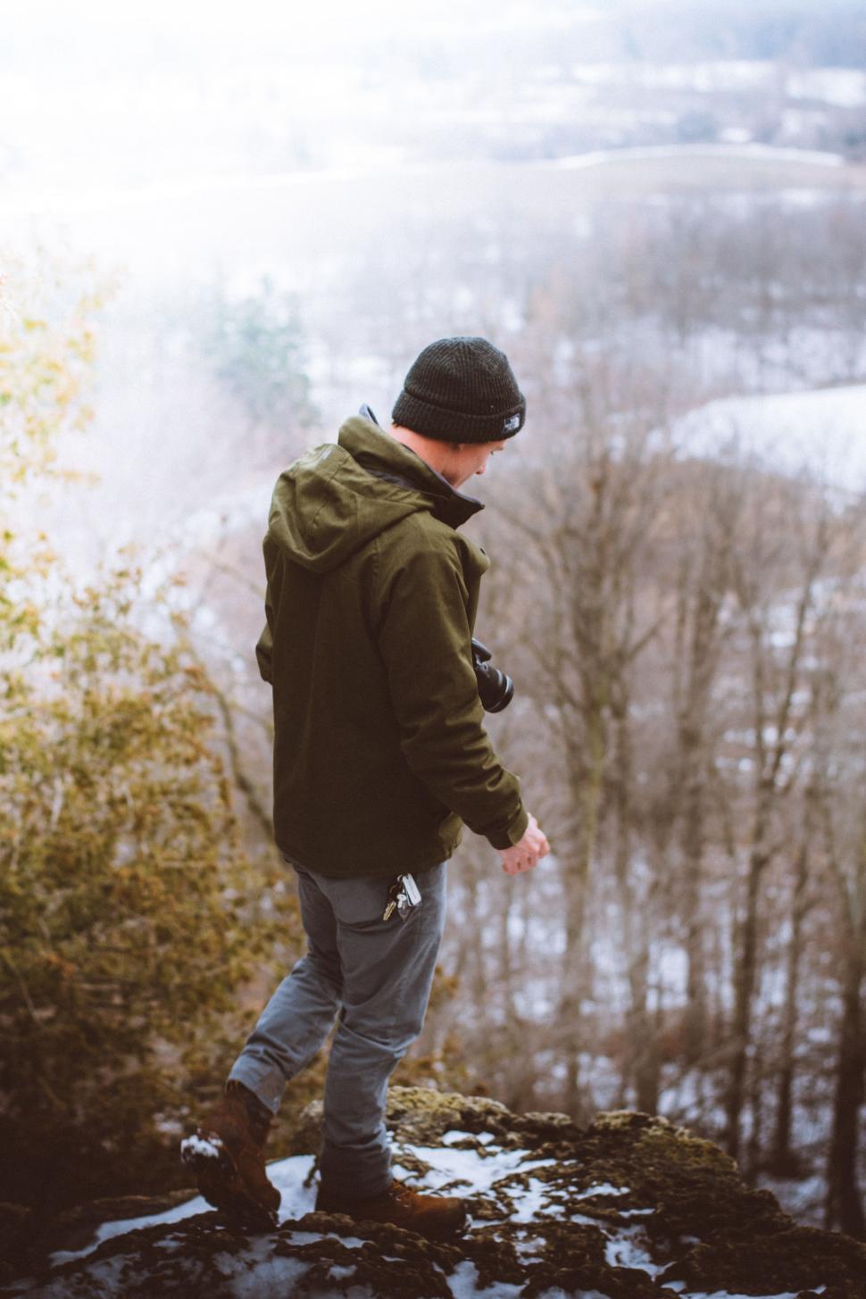 Free Image of Man Standing on Snow Covered Hill 