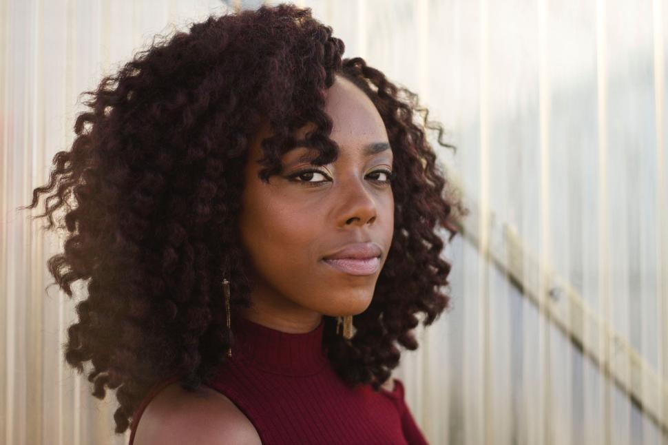 Free Image of Woman With Curly Hair Wearing a Red Dress 
