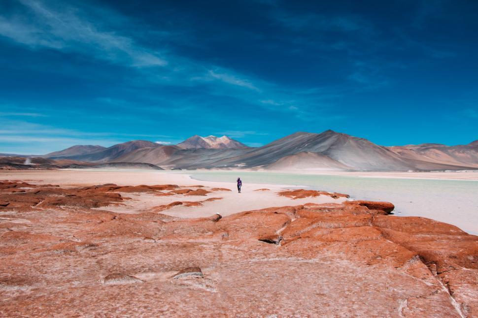Free Image of Person Standing on Rock in Desert 