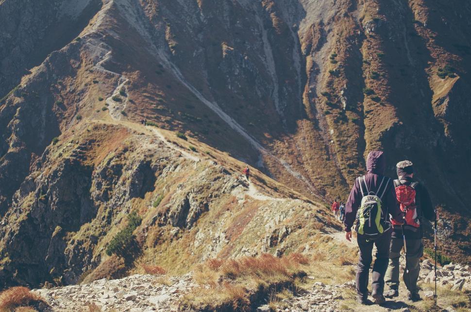 Free Image of Couple Standing on Mountain Summit 