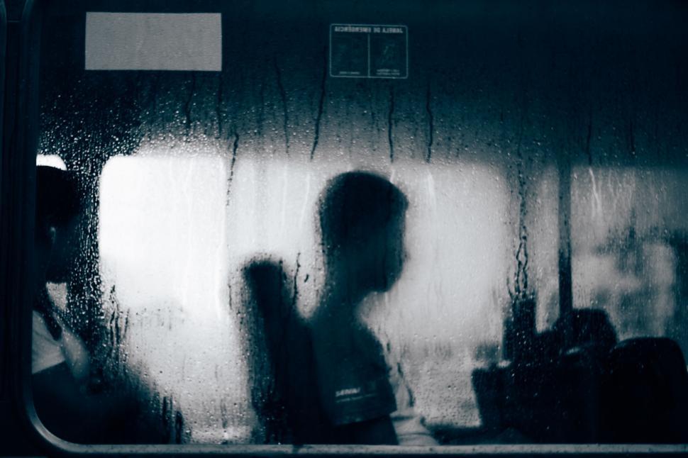 Free Image of Person Standing Next to Window in Train 