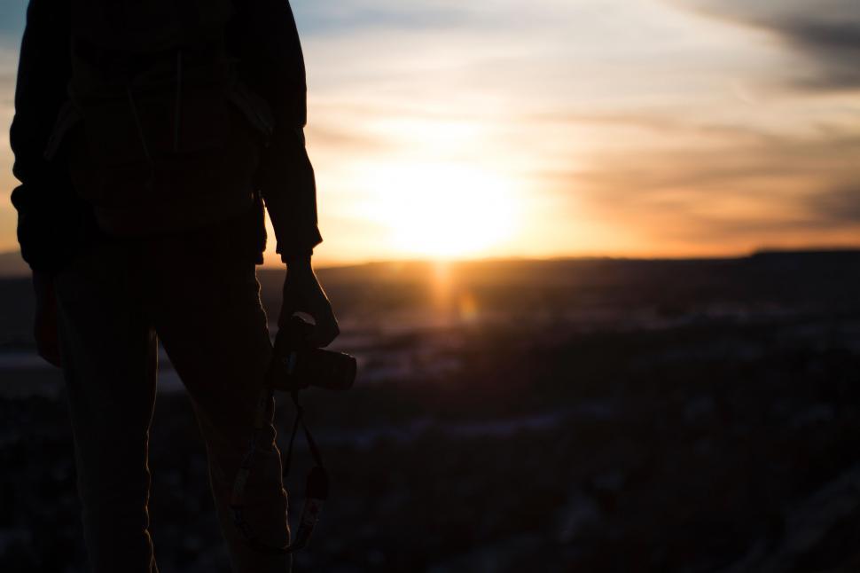Free Image of Person Standing on Hill at Sunset 
