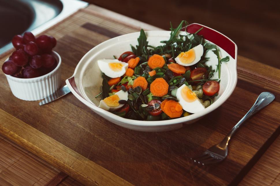 Free Image of A Bowl of Food on a Wooden Table 